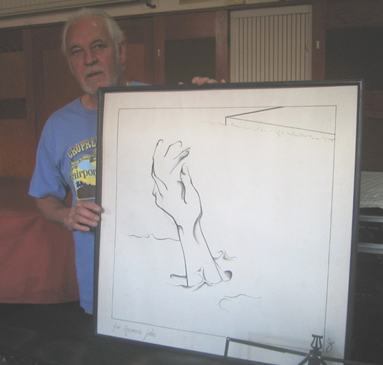 Gary Brooker, in his barn, shows how the picture would look when framed