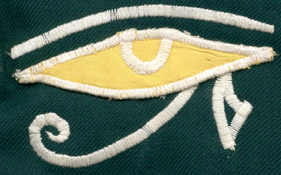 The magic-eye symbol that adorns the upper arm facing the audience when one wears this coat to play a piano stage right