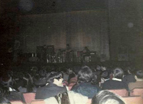 From left to right on the stage are Gary, David, BJ, Robin, Matthew. The PA speakers on either side are Voice of the Theatres